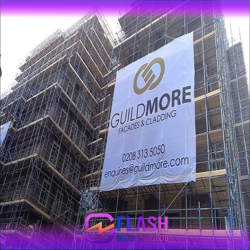 Guildmore branded scaffold banner on a building site
